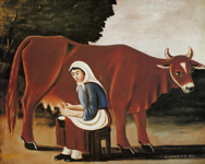 Женщина доит корову